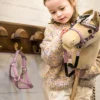 meisje met hobbyhorse en halster aan kapstok paardenmeisje